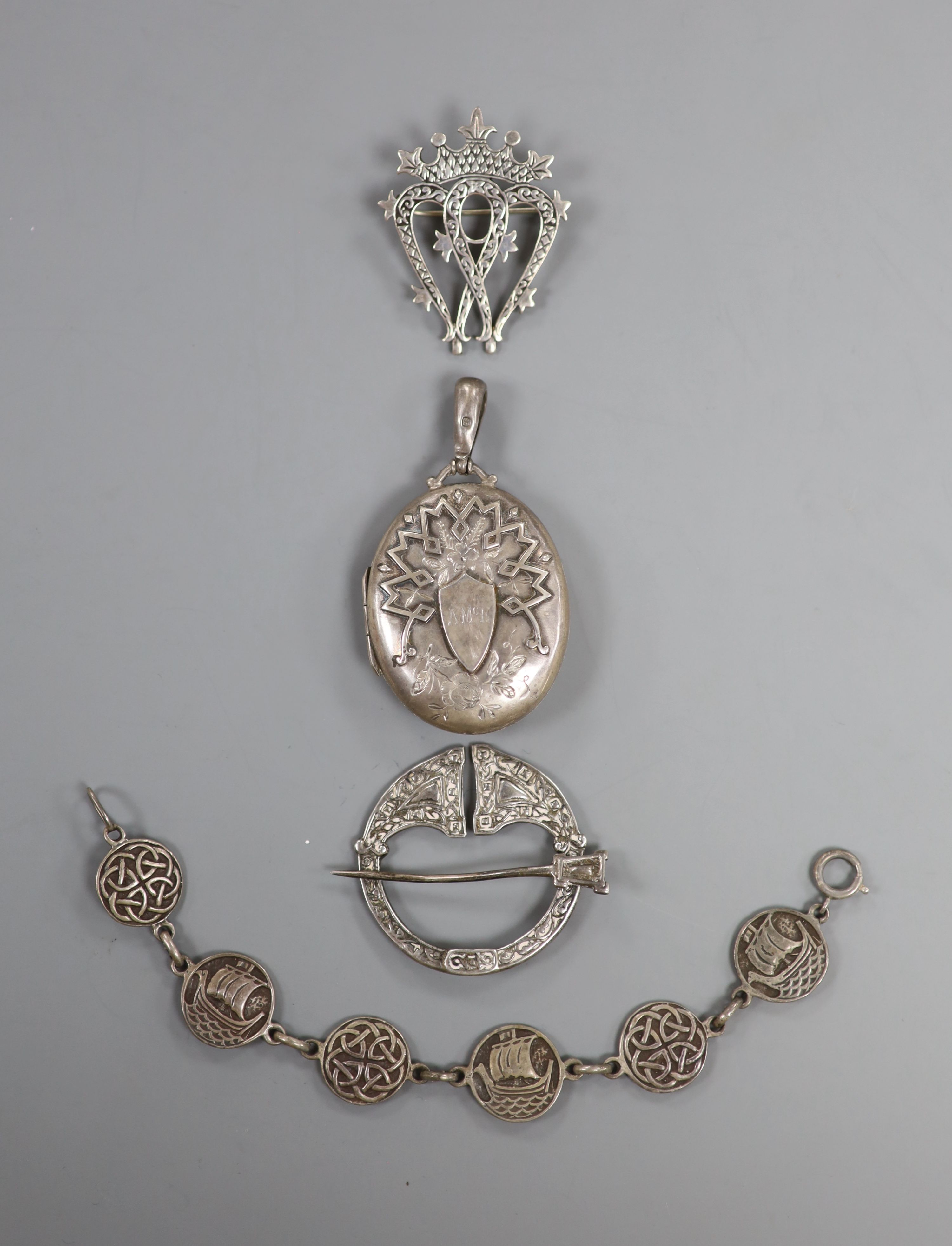 A Scottish silver Iona coronet mounted brooch, 44mm, a white metal Celtic brooch , a silver locket and a white metal bracelet.